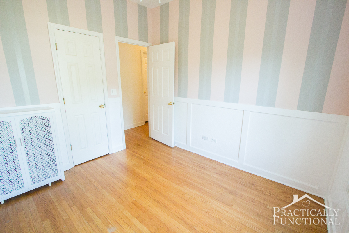 There is textured wallpaper inside each panel of this DIY wainscoting in this gorgeous nursery