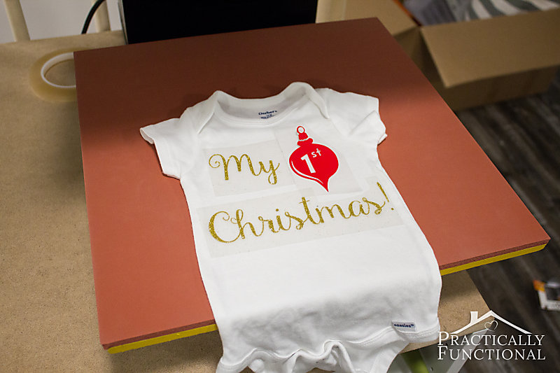 Position the heat transfer vinyl on the plain onesie and then press with an iron or heat press